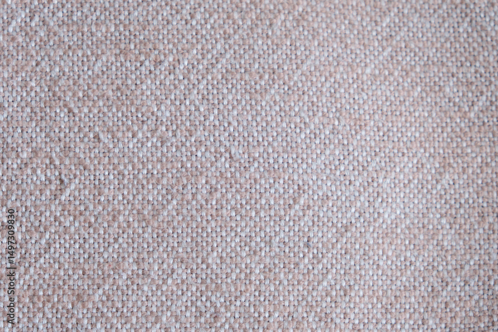 Fototapeta premium Close-up of beige woven textile texture. Macro shot of coarse fabric pattern with visible interlaced threads. Interior design and textile industry concept. 