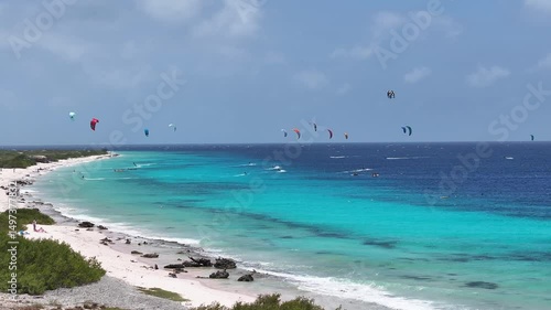Kiteboarding Bonaire In Kralendijk Bonaire Netherlands Antilles. Bird Eye View Of Stunning Parasailing Scene Over A Blue Ocean. Paradise Island Landscape Leisure Vibrant.