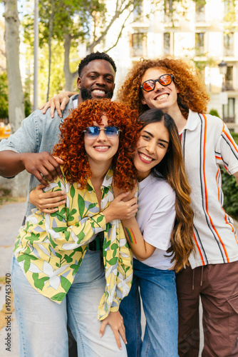Group of diverse friends embracing in urban setting