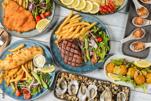 Wallpaper Mural Delicious Seafood and Steak Feast Presented on Elegant Plates at a Coastal Eatery During a Sunny Afternoon Torontodigital.ca