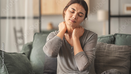 Obraz na plátně Woman suffering from neck pain in home