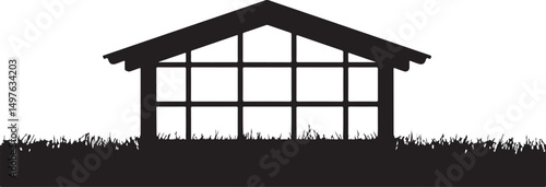 Silhouette of a Small Greenhouse in Grass