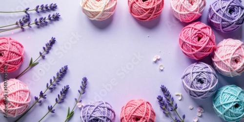 Pastel yarn balls and lavender flowers arranged artistically on a light purple background, creating a charming and delicate scene perfect for crafting projects or springtime themes.