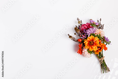 Autumn bouquet with pink yellow purple asters, orange dahlias, white background, minimal flatlay style, floral postcard design, celebration decor, top view, bright seasonal autumn composition