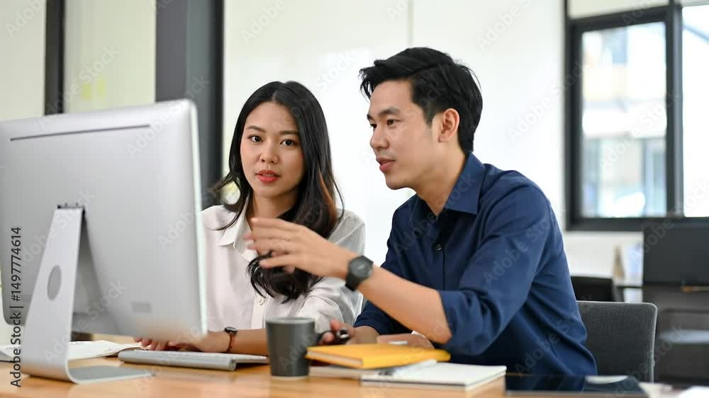 Two Business Colleagues Working Together On Computer Two Business Colleagues Working Together On Computer