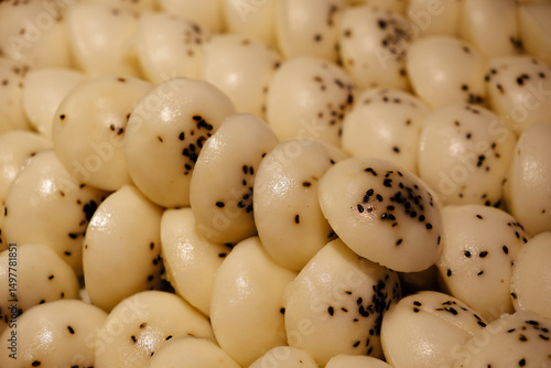 many Chinese rice cakes with black sesame seeds