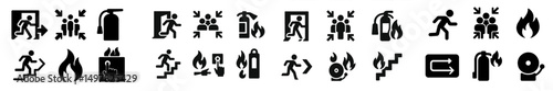 Emergency exit signs and safety icons displayed in a public building during a fire drill