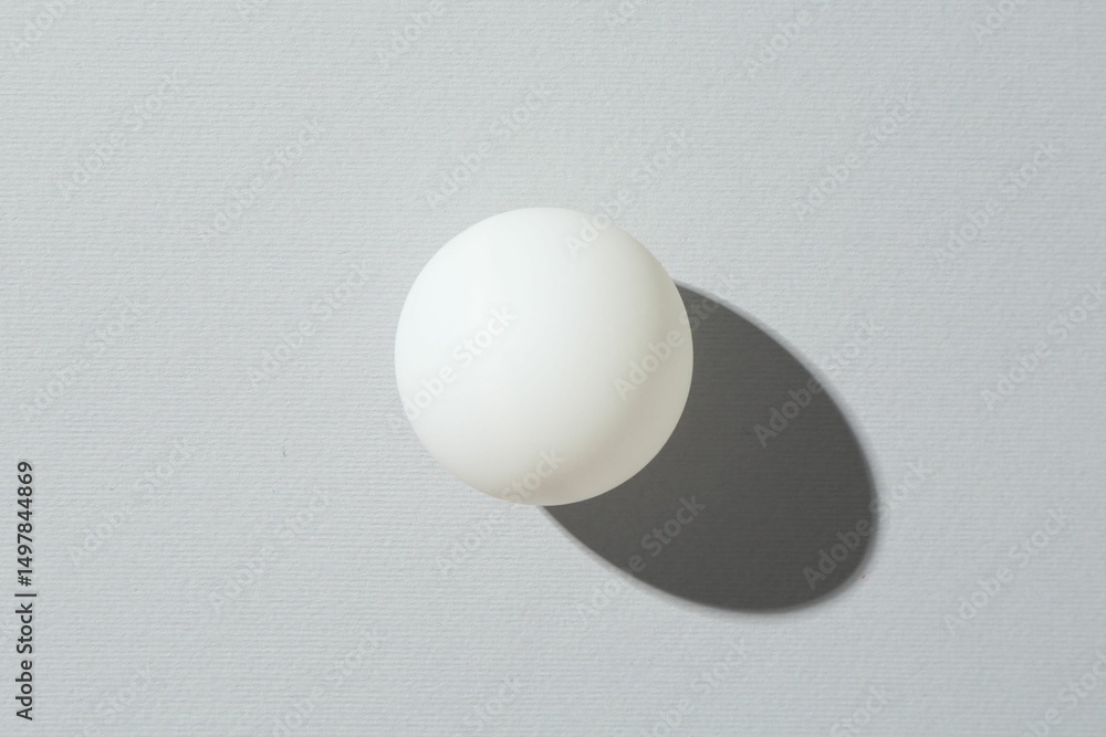 One ping pong ball on light background, top view One ping pong ball on light background, top view