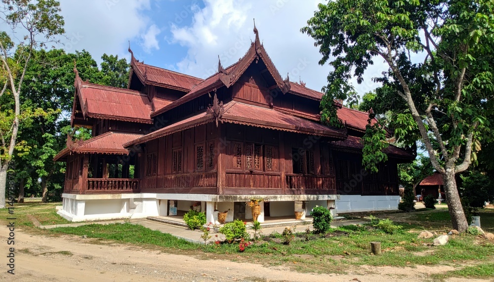 Fototapeta premium Serene Teak Monastery Amidst Lush Greenery in Myanmar
