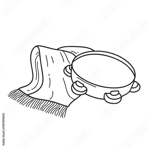 A tambourine rests next to scarves on the floor