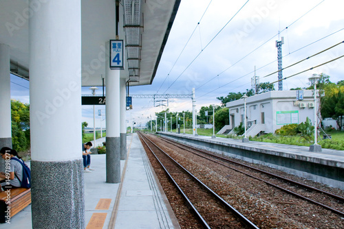 Photography Taiwan May 21, 2024: A railway track curving into the distance beside a station