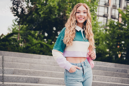 Portrait of pretty young girl smile hold rucksack wear top stairs city center outdoors