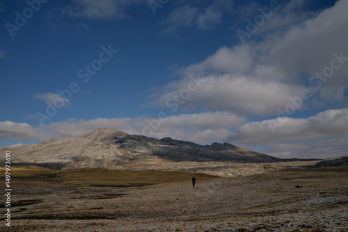 mountain landscape with person walking in distance
