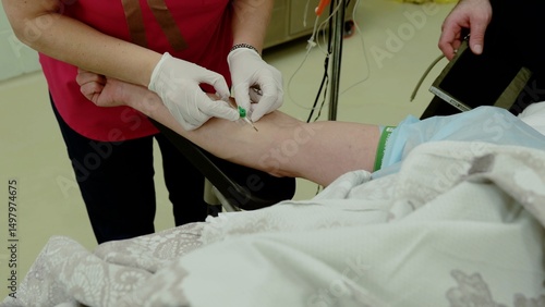 Fotografia Nurse wearing gloves carefully inserts an iv catheter into a patient's arm, ensu