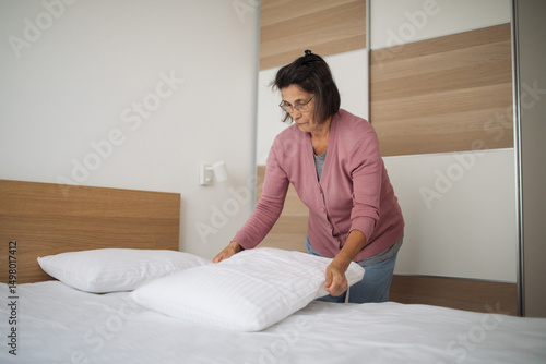 Host prepares the room for her next guest with care
