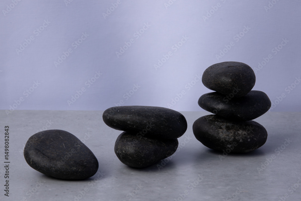 Balanced stones create a calm arrangement on a smooth surface in neutral tones Balanced stones create a calm arrangement on a smooth surface in neutral tones