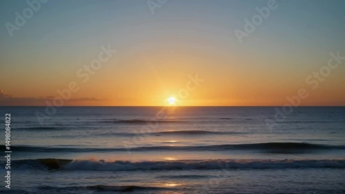 Serene sunset over calm ocean waves during twilight hours  