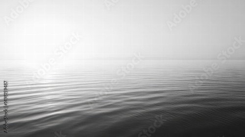Serene Seascape: A captivating monochrome image captures the tranquil vastness of the open sea, with its gentle waves, and ethereal mist at the horizon, inducing a sense of calm and wonder.
