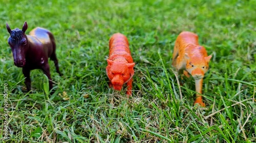 Wallpaper Mural Group of animals toys in line isolated over green grass background. animals toys like tiger, horse, Wild Rhino lion and goats etc Torontodigital.ca