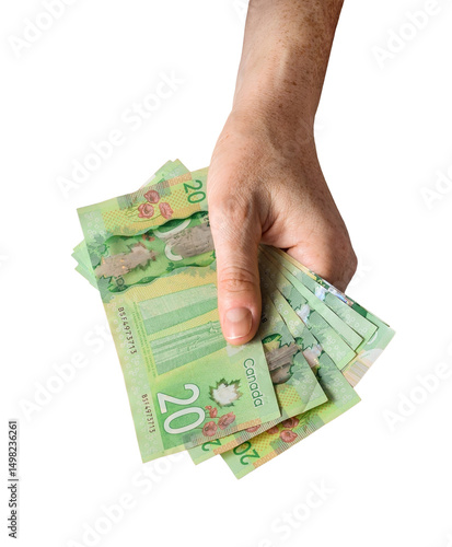 Foto Person's hand holding twenty dollar canadian cash money bills isolated cutout on