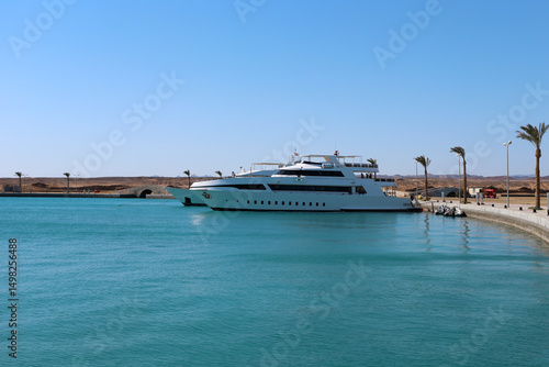 Luxury White Yacht Moored at Port Ghalib Marina, Egypt – Calm Turquoise Waters and Desert Landscape in the Background
