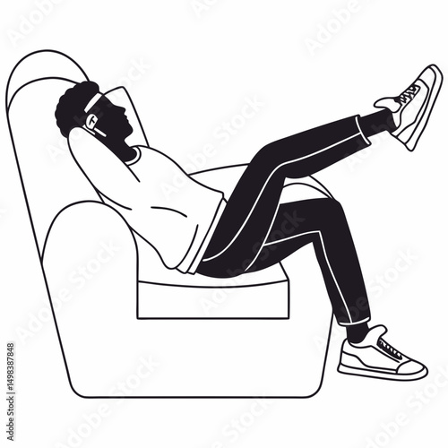Man relaxing in armchair listening to music