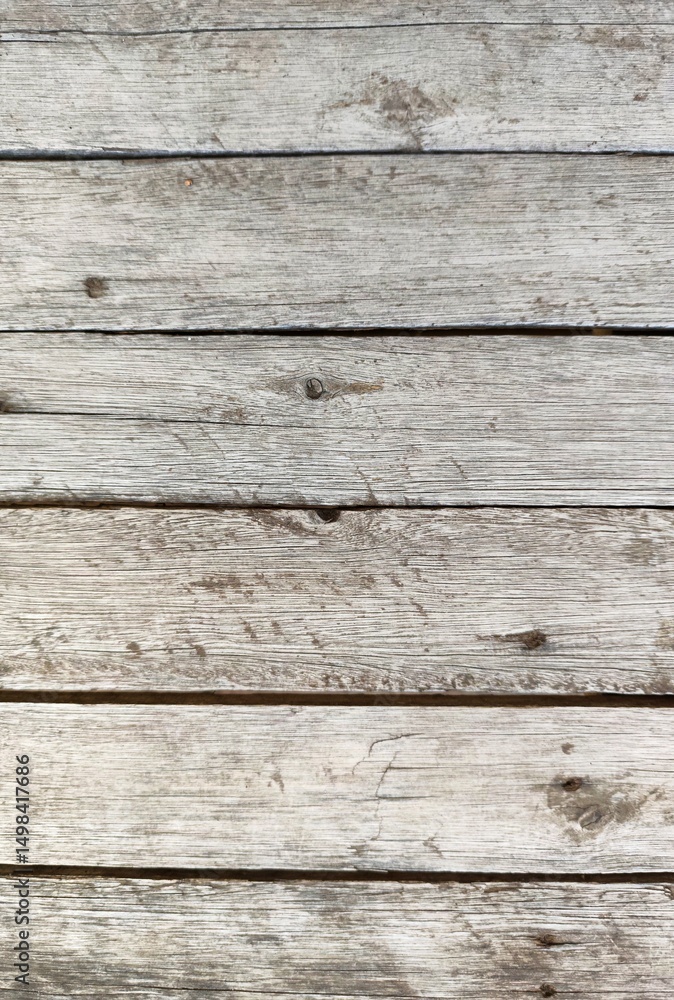 Close-up of aged wooden planks, with rustic and weathered surface, displaying marks of use and color variations that convey a sense of history and rusticity. Close-up of aged wooden planks, with rustic and weathered surface, displaying marks of use and color variations that convey a sense of history and rusticity.