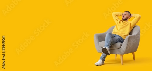 Young man relaxing in armch...