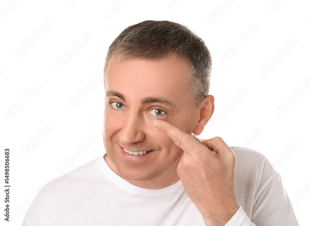 Mature man putting in contact lenses on white background Mature man putting in contact lenses on white background
