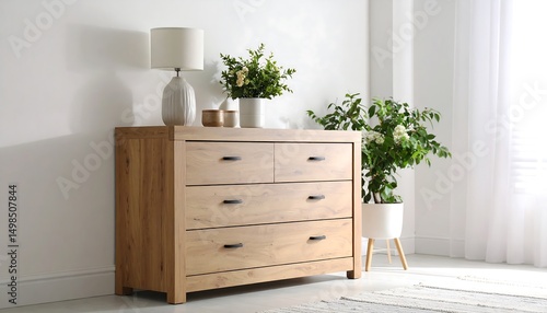 Cozy wooden chest of drawers with decor and plants in a bright bedroom.