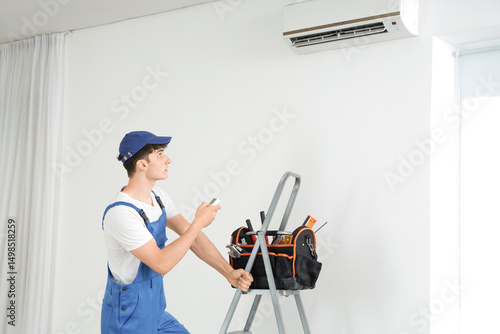Male worker repairing air c...