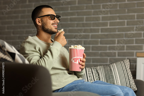 Young man with 3D glasses a...