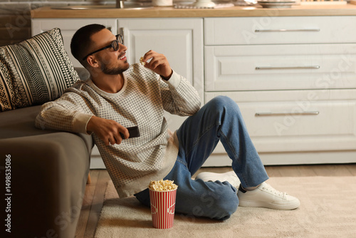Young man with 3D glasses a...