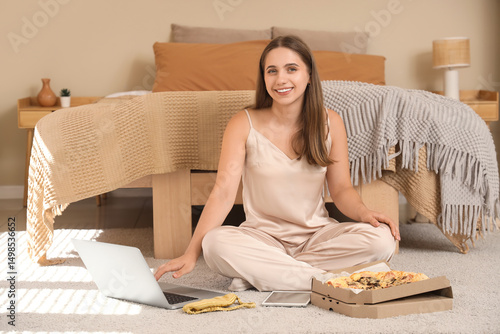Young woman in pajamas with...