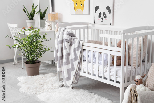 Stylish white crib with pla...