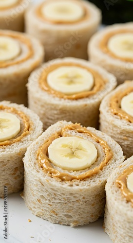 Sandwich 'sushi' rolls with peanut butter and banana. Sliced pinwheels, no-crust, perfect for lunchboxes.