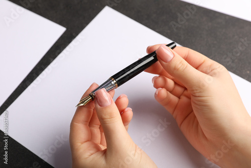 Female hand writing in blan...