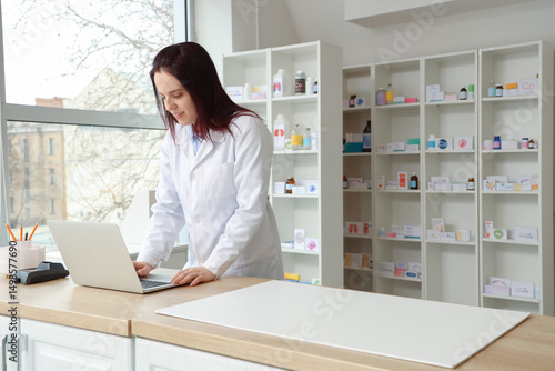 Female pharmacist working w...