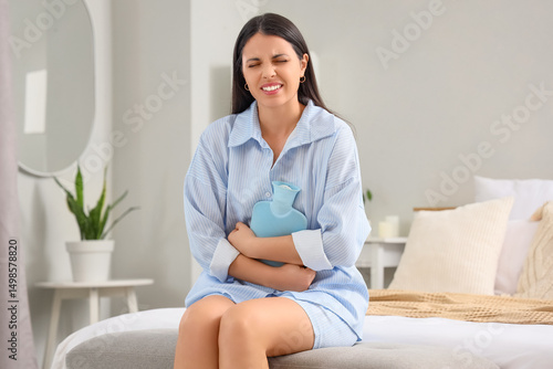 Young woman with hot water ...