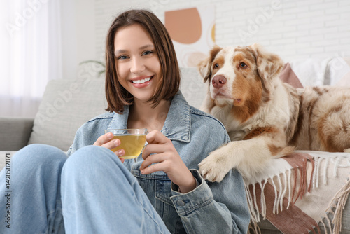 Happy young woman with cup ...