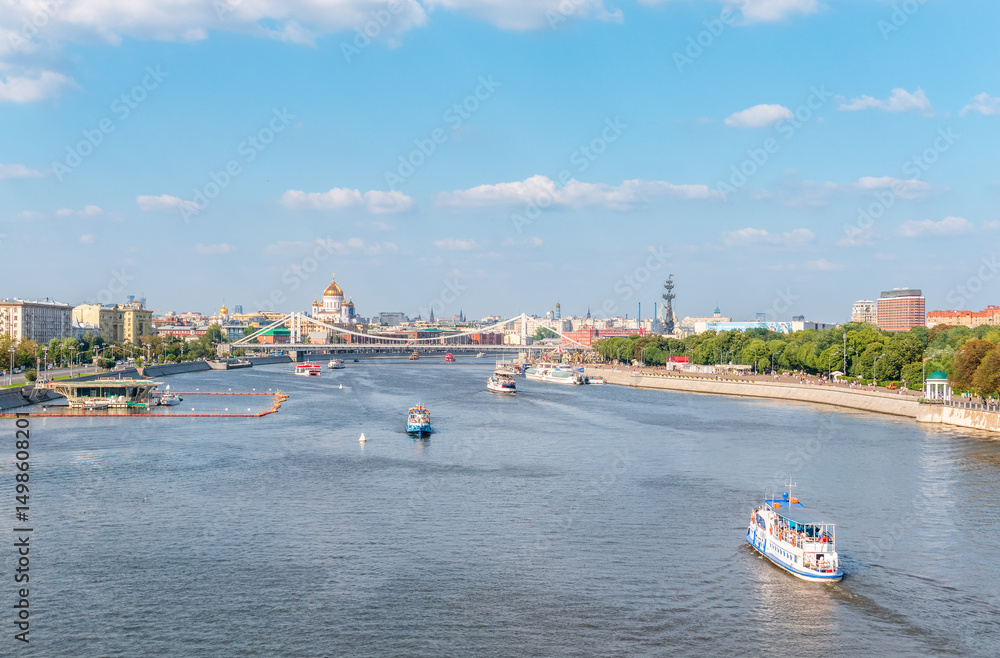 Naklejka premium Cruise ship sails on the Moscow river in Moscow city center, popular place for walking.