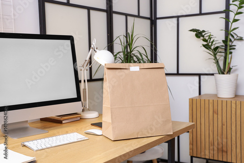 Paper bag on desk in office...