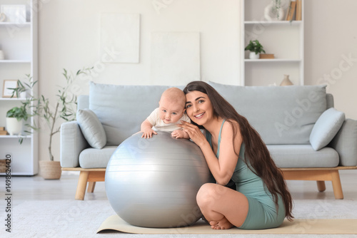 Happy mother and baby exerc...