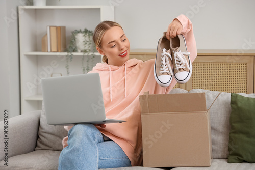 Young woman with laptop tak...
