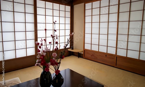 Serene minimalist room with tatami mats, shoji screens, and floral arrangement
