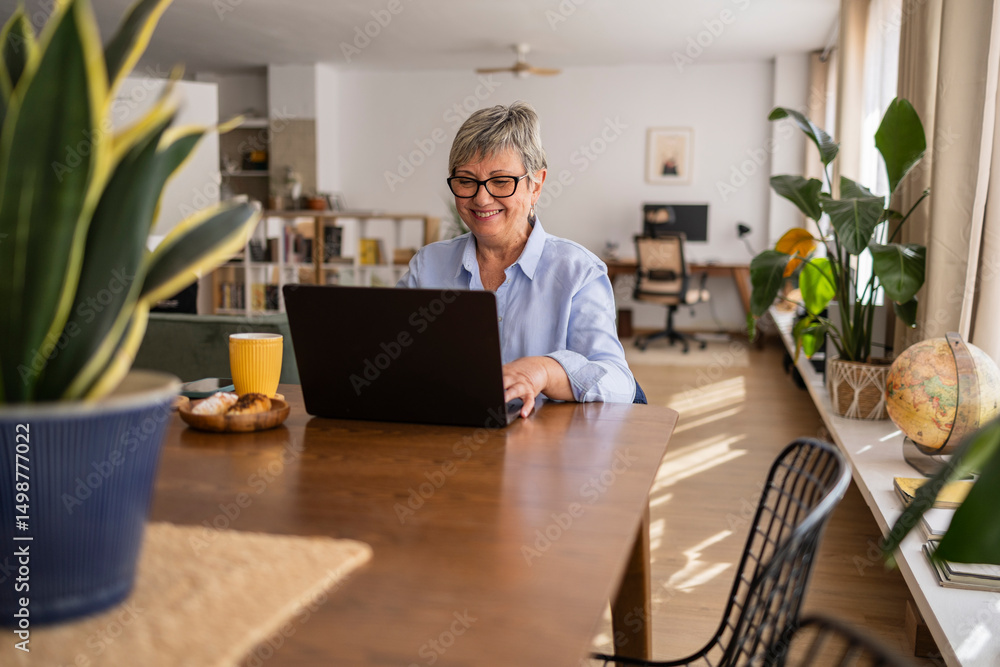 Senior woman working from home in a comfortable home office setting Senior woman working from home in a comfortable home office setting