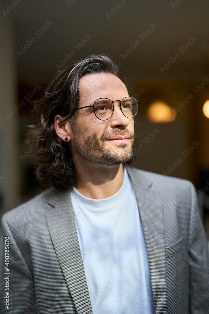 Thoughtful handsome mature businessman wearing eyeglasses at office Thoughtful handsome mature businessman wearing eyeglasses at office
