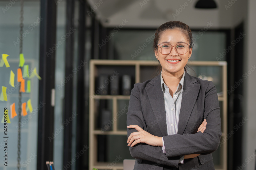 Smiling and elegant Asian businesswoman in business suit and office work. Smiling and elegant Asian businesswoman in business suit and office work.