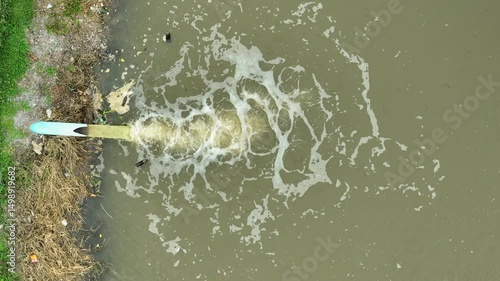 Agricultural water usage depicted by water release into a canal, emphasizing irrigation infrastructure that supports farming productivity and resource management.
