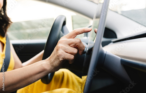 Wallpaper Mural Mature woman using digital tablet in electric car Torontodigital.ca